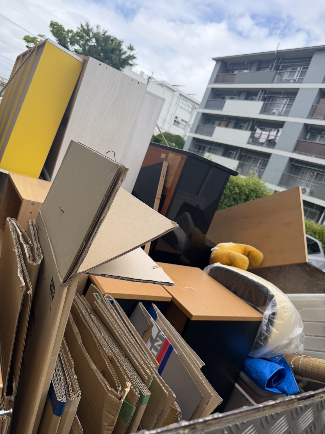 博多駅近くの不用品回収で、収納家具や机、大量の段ボールを積んだトラックの荷台
